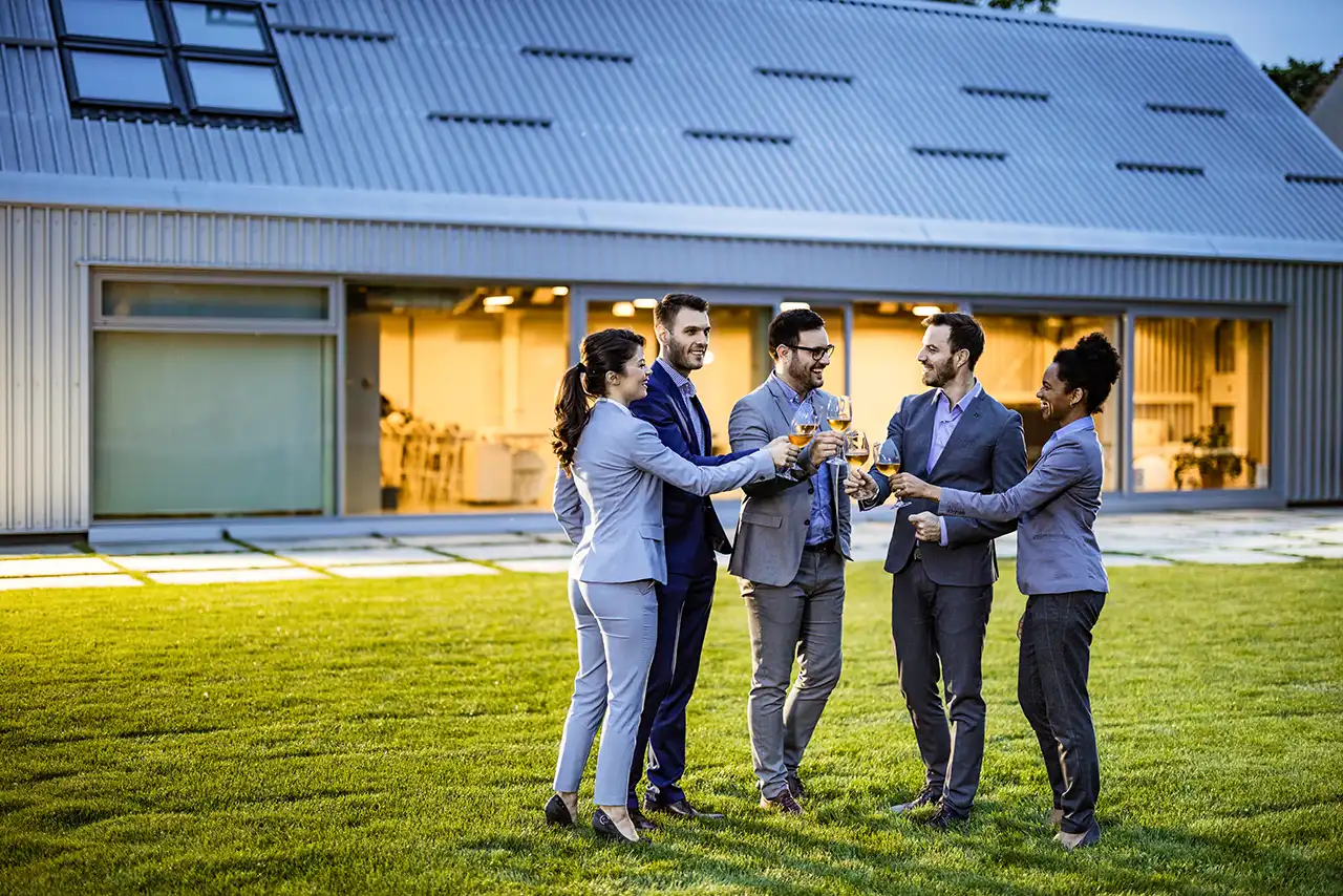 coworkers-toasting-on-lawn-at-corporate-retreat