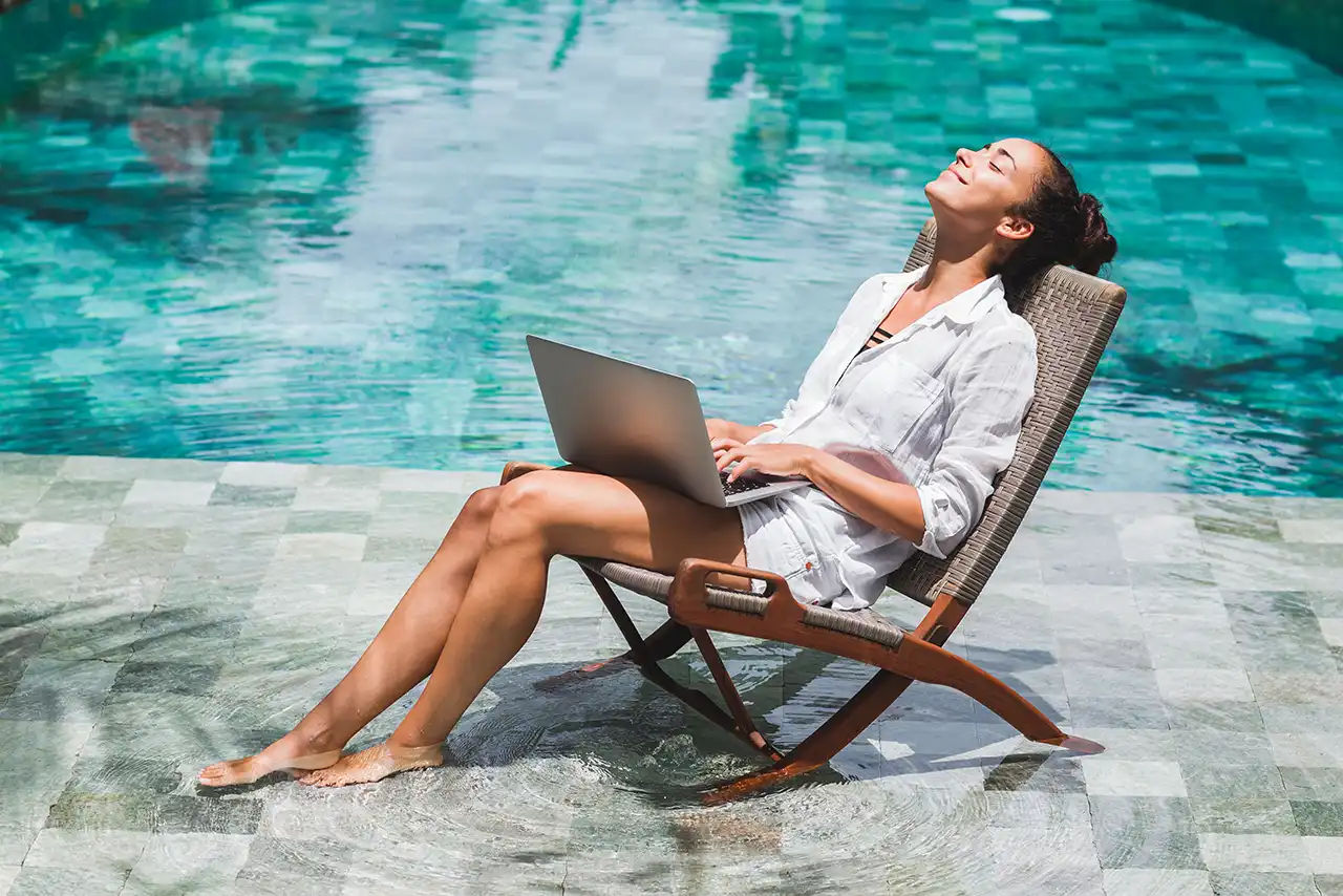 woman-working-on-laptop-while-sitting-in-a-pool